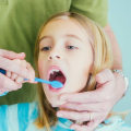 At what age should teeth cleaning begin?